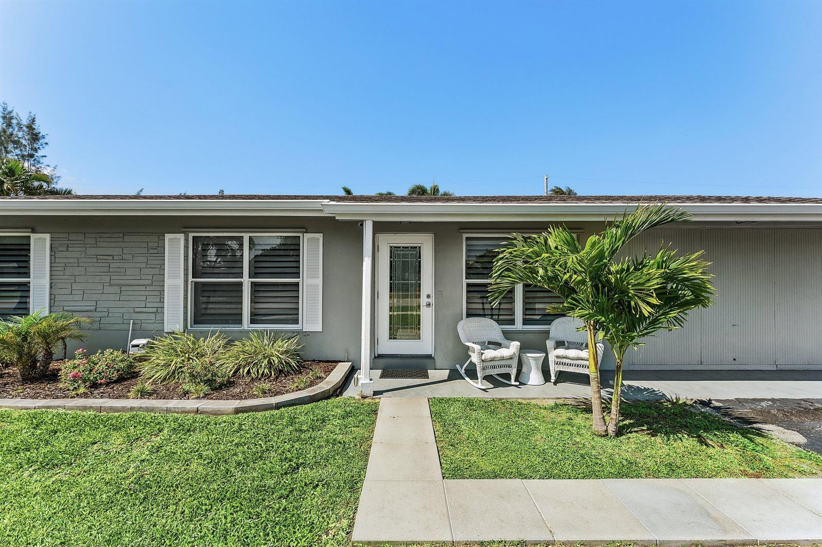 A single-story gray house with a front lawn, driveway, and white shutters — 517 Ibis Drive, Delray Beach FL 33444, DELRAY BEACH, FL