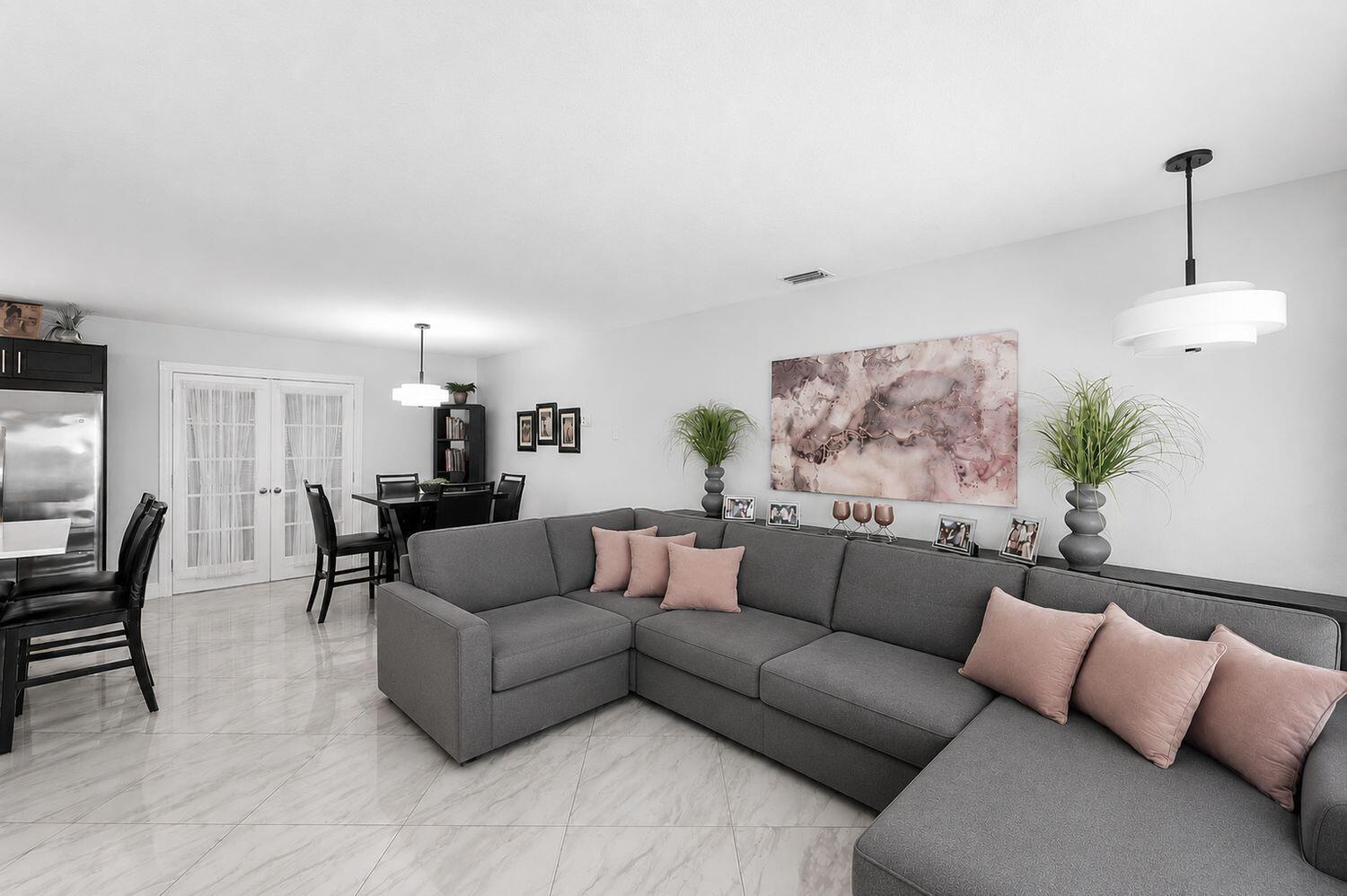 A single-story house exterior features a gray facade, a front porch, and a small palm tree — 517 Ibis Drive, Delray Beach FL 33444, DELRAY BEACH, FL