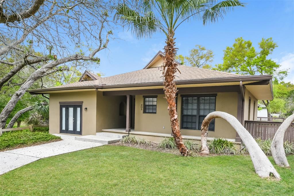 A single-story house with tan stucco siding, a covered porch, and a palm tree out front — 405 CENTER STREET, ALTAMONTE SPRINGS, FL
