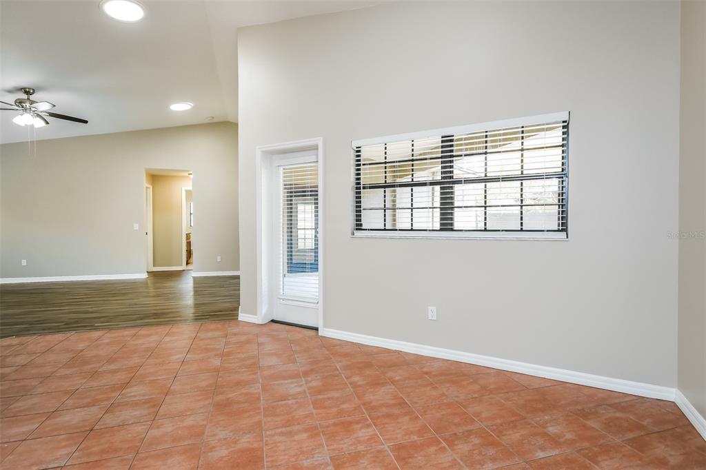 A room with tile flooring, a glass-paned door, and a window with blinds — 405 CENTER STREET, ALTAMONTE SPRINGS, FL