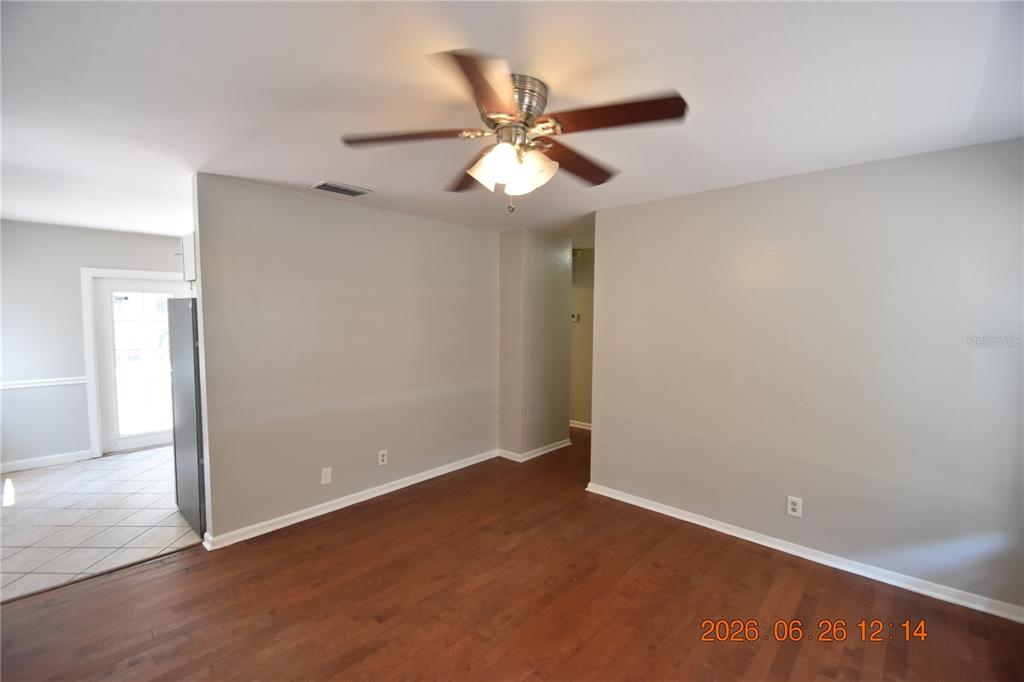 An empty room with light gray walls, dark wood flooring, and a ceiling fan — 4414 W WYOMING AVENUE, TAMPA, FL