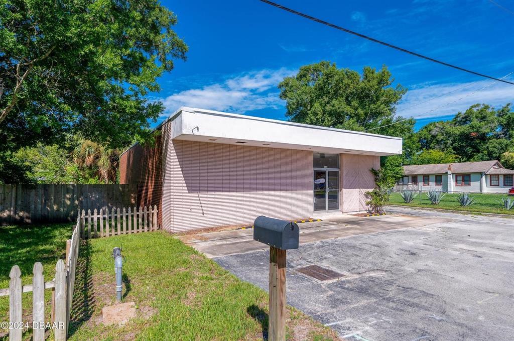 A single-story commercial building with a flat roof and a paved parking lot — 116 CENTER STREET, DAYTONA BEACH, FL