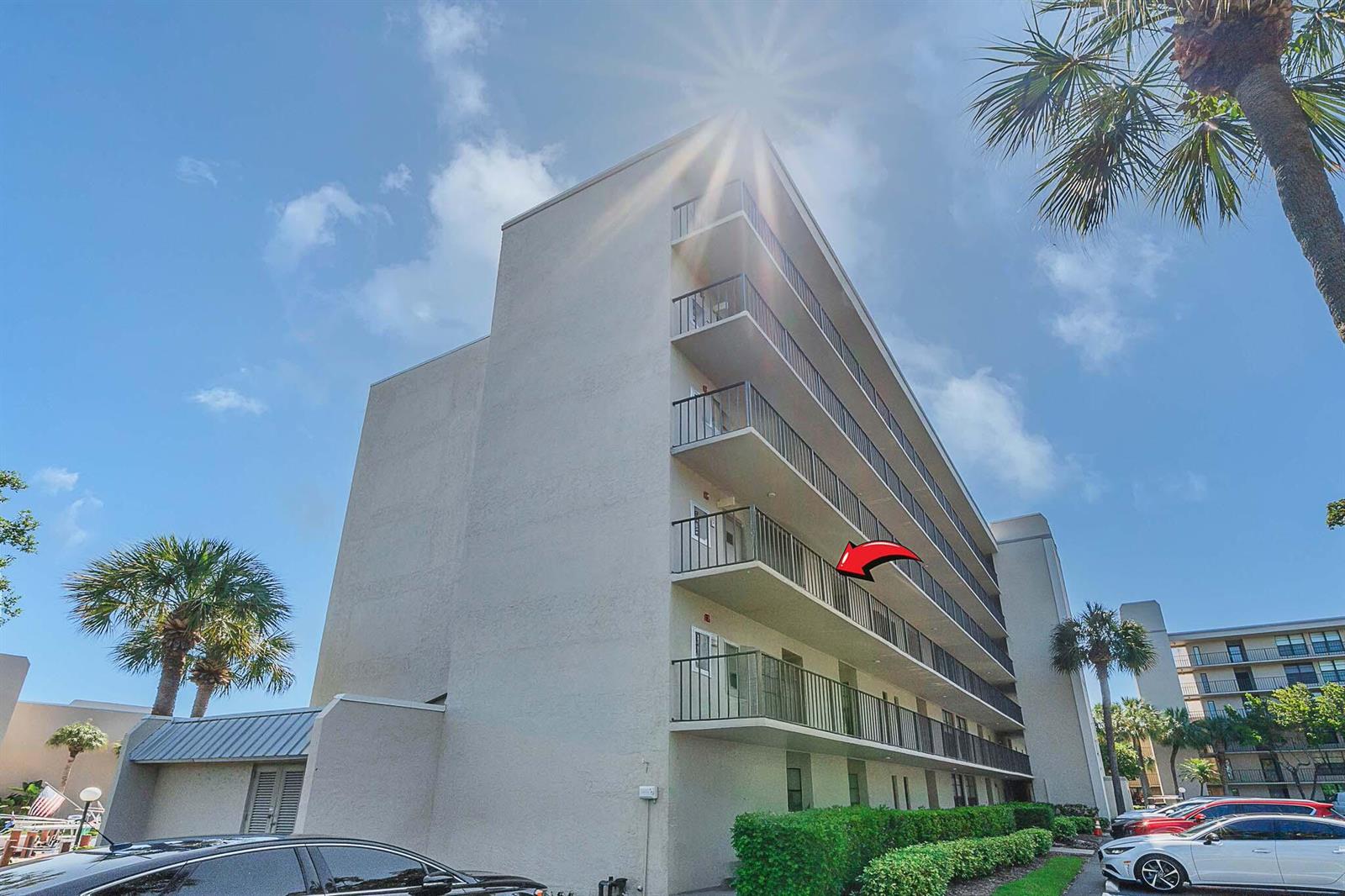 A multi-story apartment building exterior with balconies and a red arrow pointing to one unit — 17 Royal Palm Way # 3010, Boca Raton FL 33432, BOCA RATON, FL