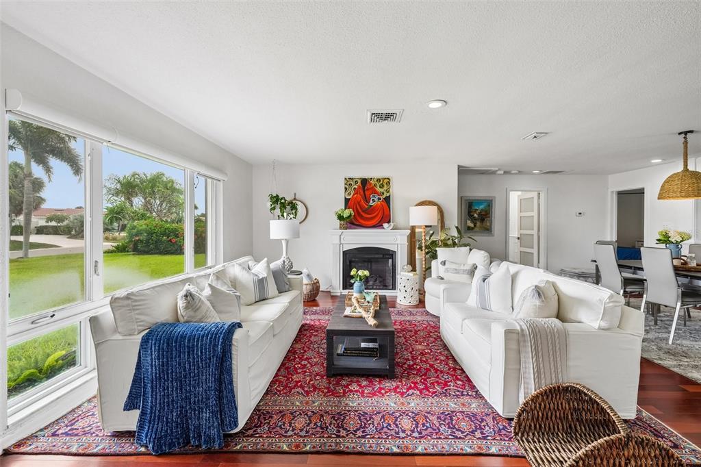 A living room features two white sofas, a red patterned rug, and a fireplace — 4379 44TH STREET S, ST PETERSBURG, FL