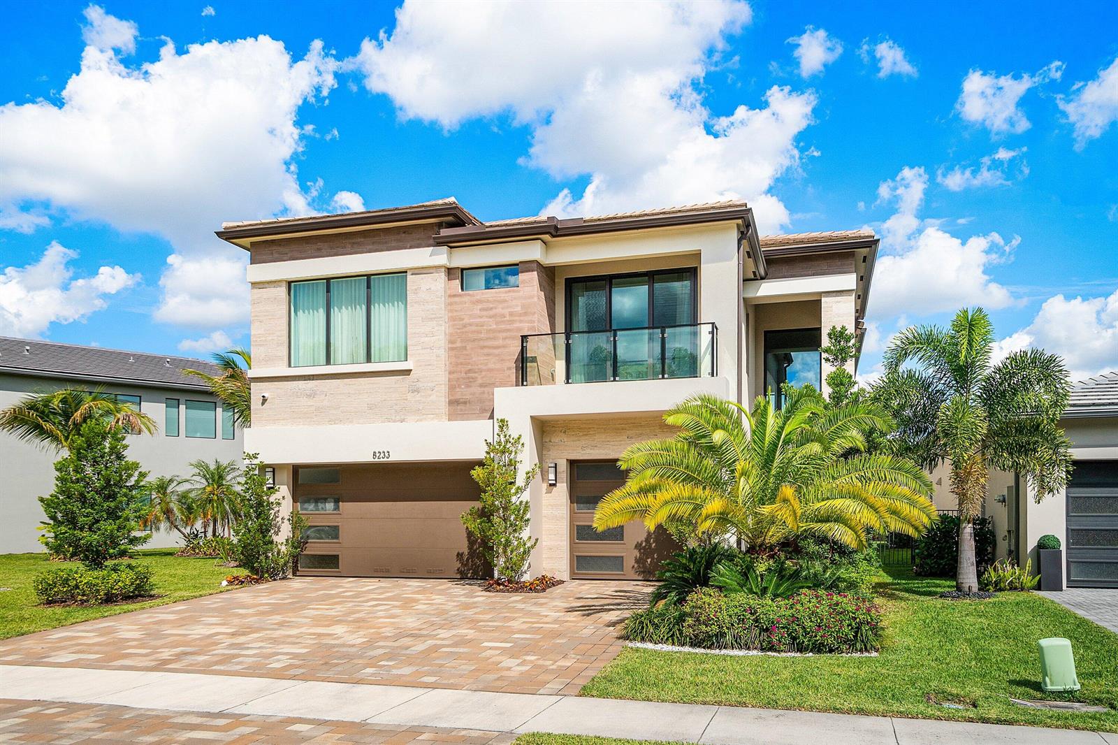 A two-story modern house with a paved driveway, two garage doors, and a second-floor balcony — 8233 Crystal Downs Avenue, Boca Raton FL 33434, BOCA RATON, FL