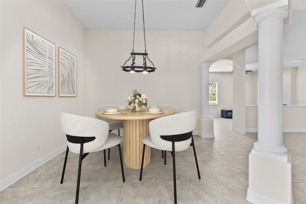 A dining area features a round wooden table, four modern chairs, and a metal chandelier — 4116 WOODACRE LANE, TAMPA, FL