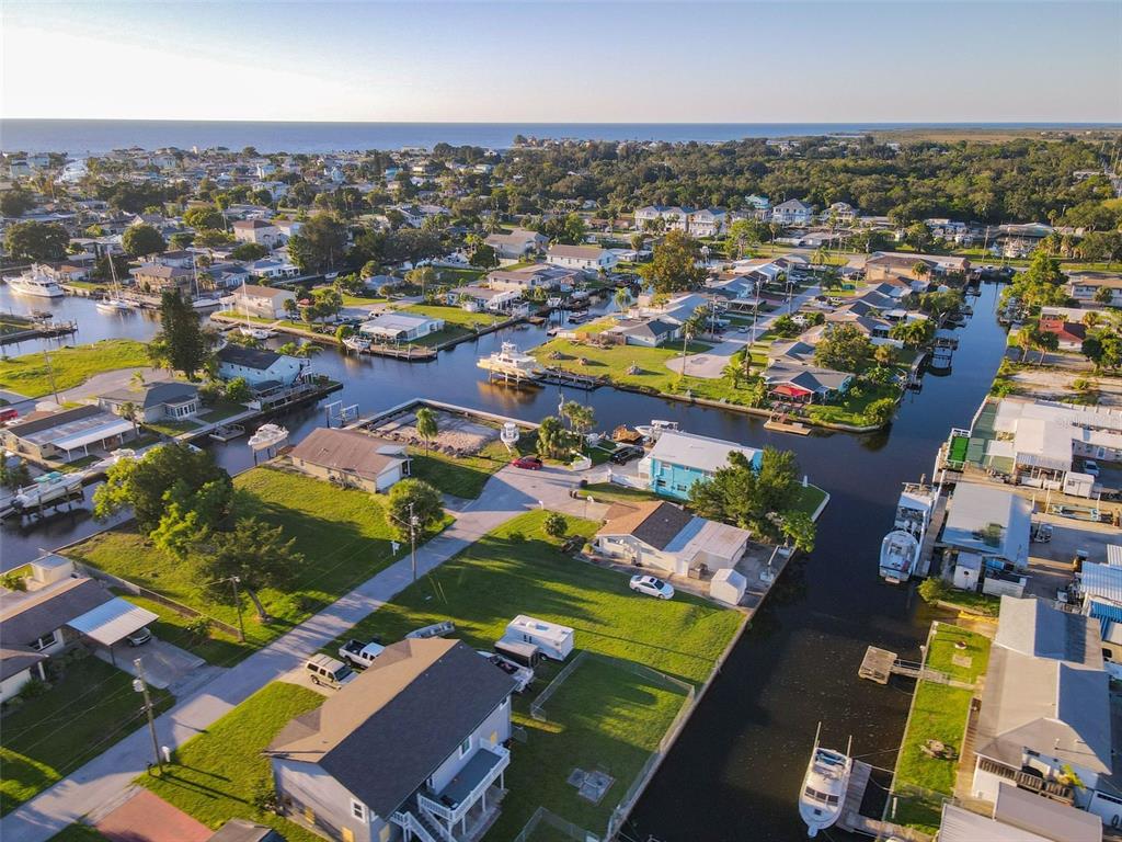 An aerial view of a coastal neighborhood featuring houses along canals with docked boats — Lot 33 JUDY AVENUE, HUDSON, FL