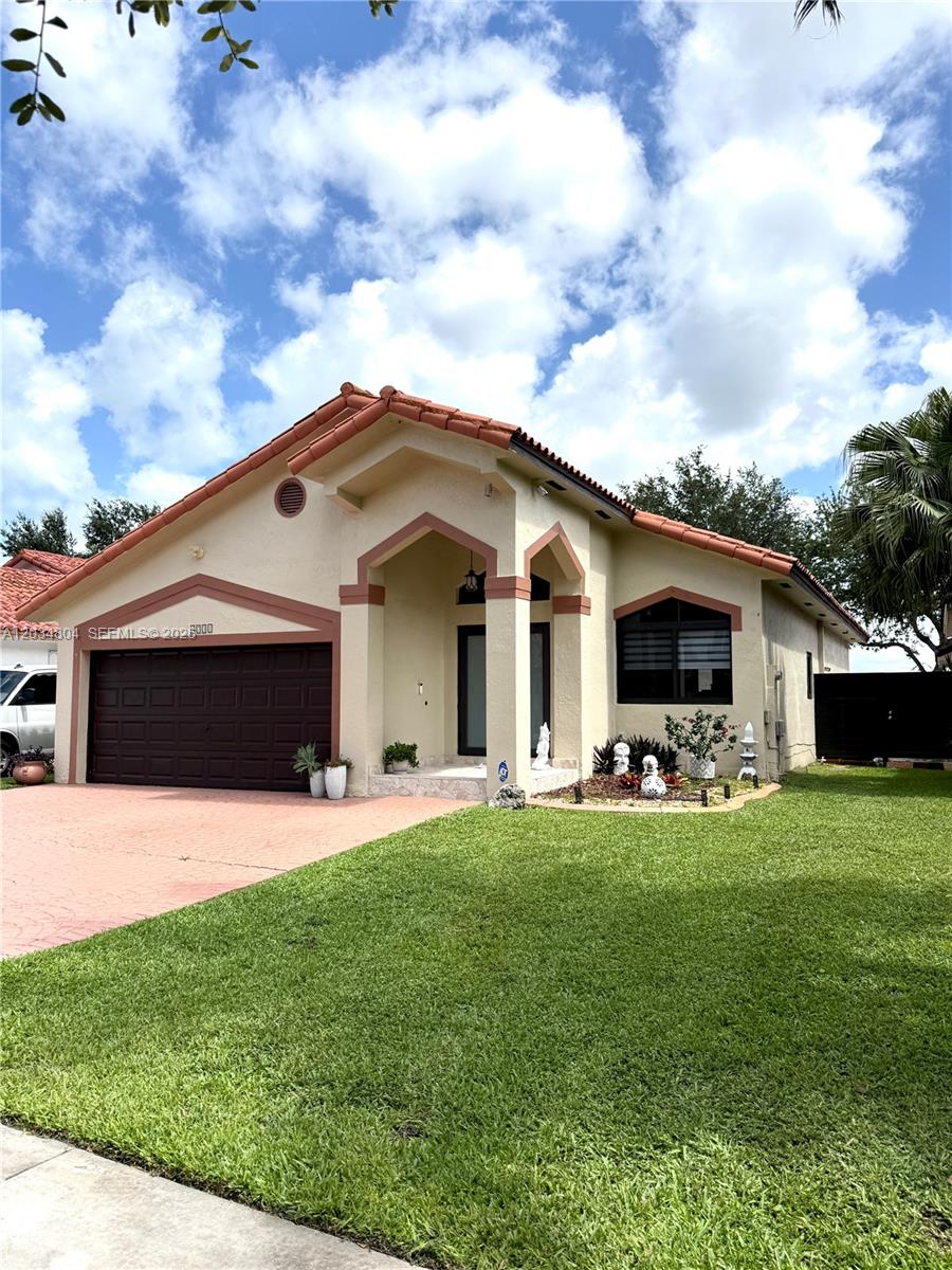 A single-story house with a brown garage door, tiled roof, and a front lawn — 8731 NW 153rd Ter, Miami Lakes FL 33018, MIAMI LAKES, FL