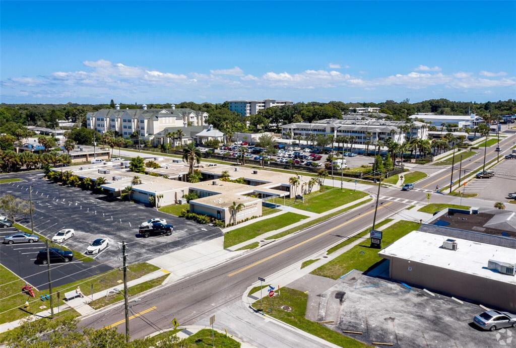 An aerial view shows a commercial building complex with parking lots and surrounding streets — 1201 S HIGHLAND AVENUE UNIT 7, CLEARWATER, FL