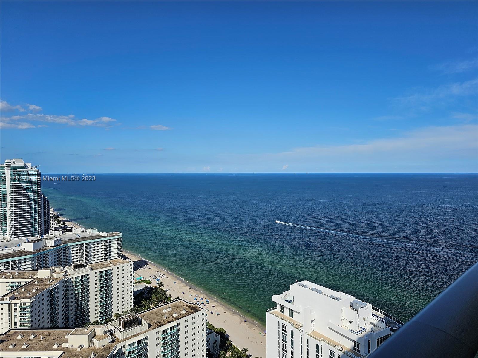 An elevated view shows a sandy beach, the ocean, and several high-rise buildings — 4111 S Ocean Dr # 3608, Hollywood FL 33019, HOLLYWOOD, FL