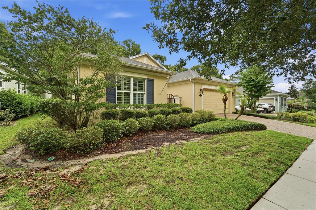 A covered entryway features a blue double door, a wooden console table, and a bench — 125 ASTERBROOKE DRIVE, DELAND, FL
