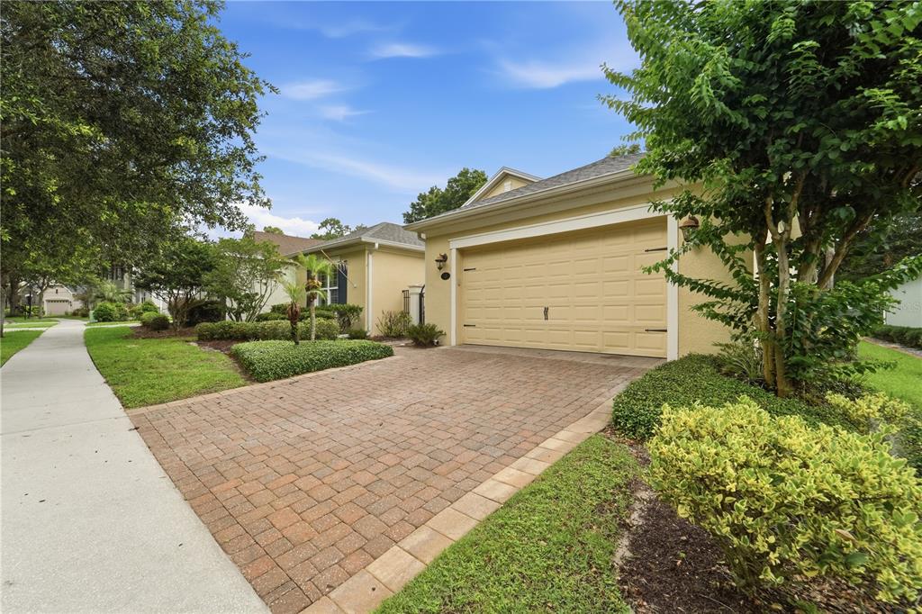 A bright foyer features a double front door, tile flooring, and a central pedestal table — 125 ASTERBROOKE DRIVE, DELAND, FL