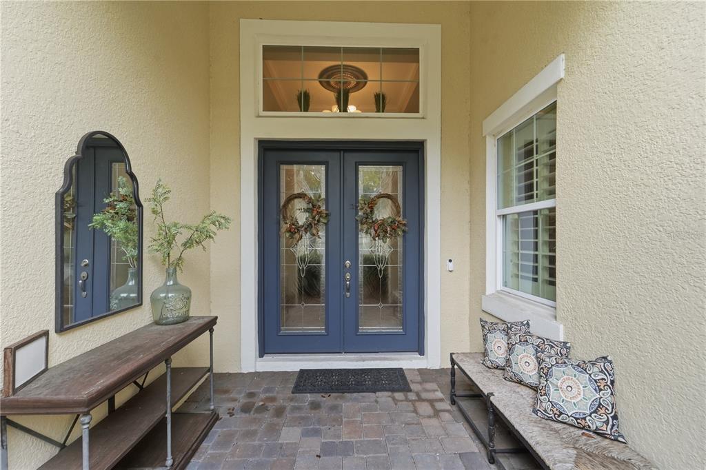 A living room features a large entertainment center, leather furniture, and a tray ceiling — 125 ASTERBROOKE DRIVE, DELAND, FL