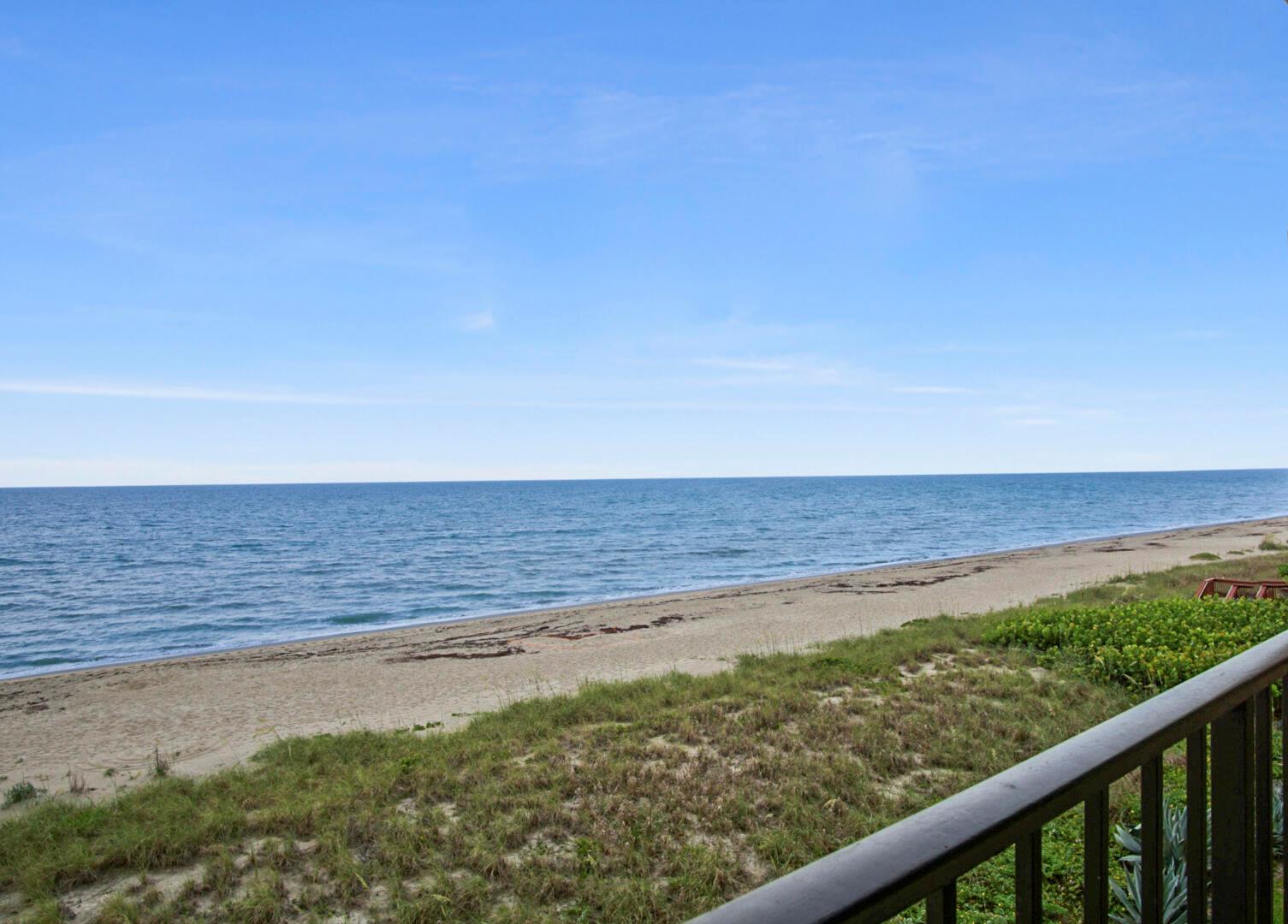 A view of a sandy beach and the ocean from a balcony with railings — 10310 S Ocean Drive # 405, Jensen Beach FL 34957, JENSEN BEACH, FL