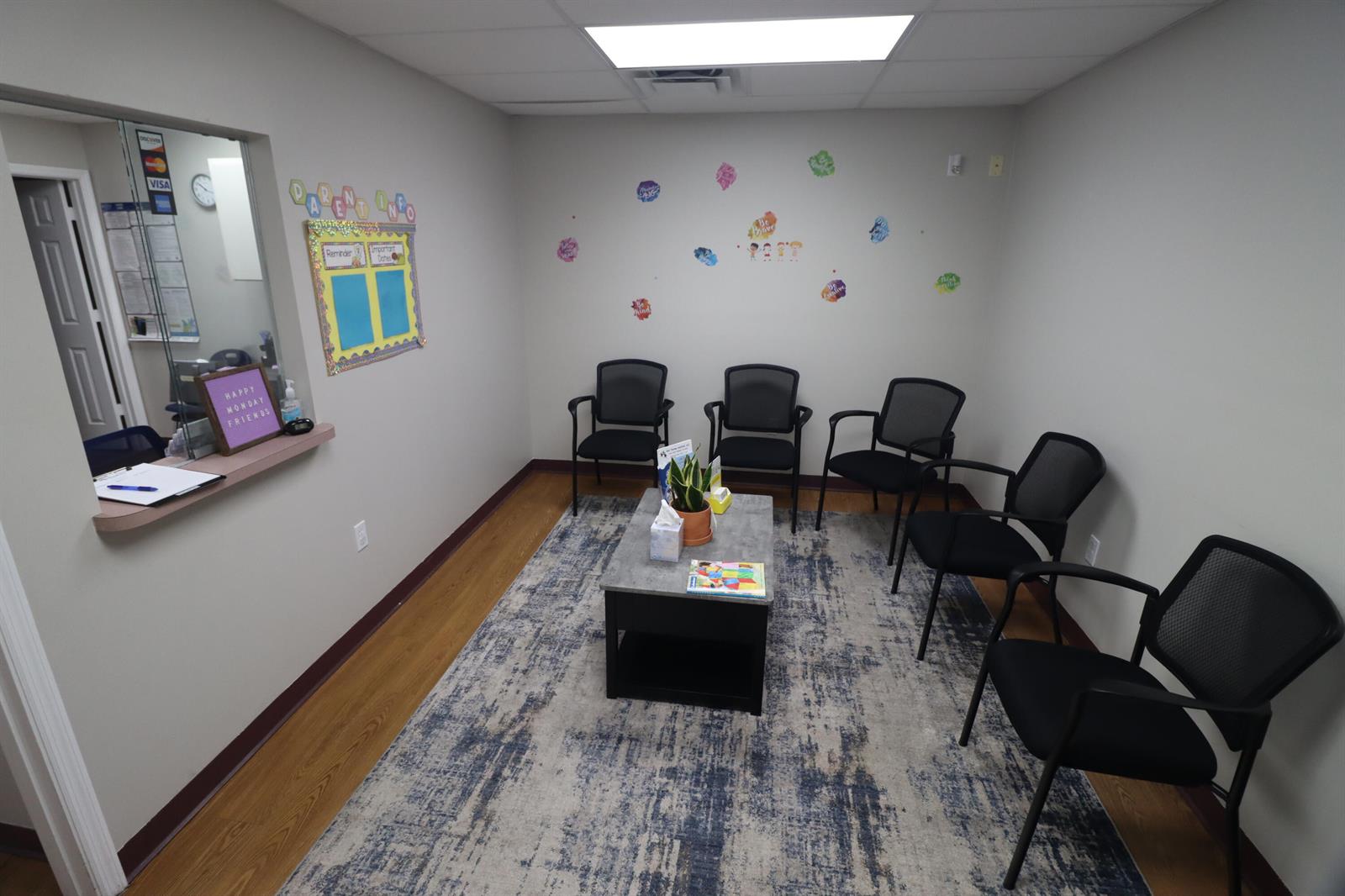 A waiting room with five black chairs, a coffee table, and a blue area rug — 111 NE 19th Drive, Okeechobee FL 34972, OKEECHOBEE, FL
