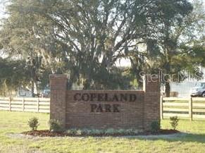 A brick monument sign for Copeland Park stands in front of a large oak tree — TBD NW 126TH TERRACE, ALACHUA, FL
