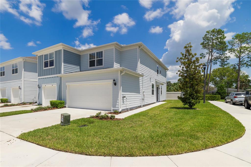 A two-story light blue house with a two-car garage and a grassy front yard — 2857 CLEVER LANE, WINTER PARK, FL