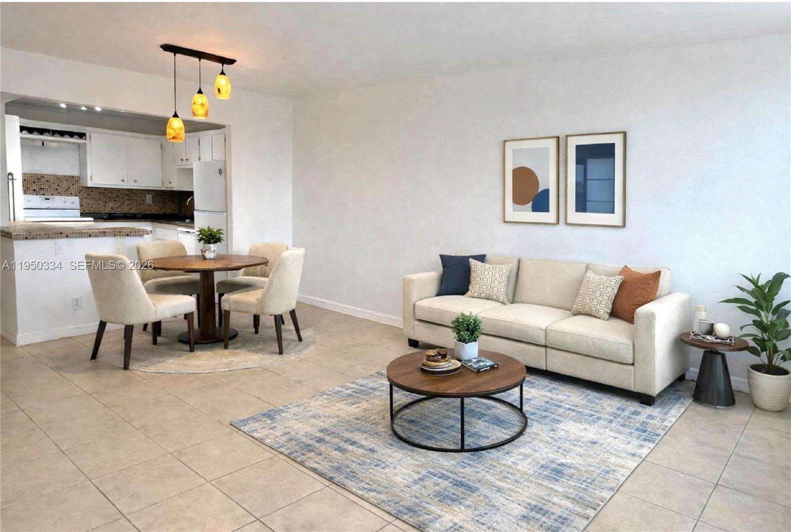 A living room and dining area feature tile floors, a beige sofa, and a round table — 2771 Taft St # 411, Hollywood FL 33020, HOLLYWOOD, FL