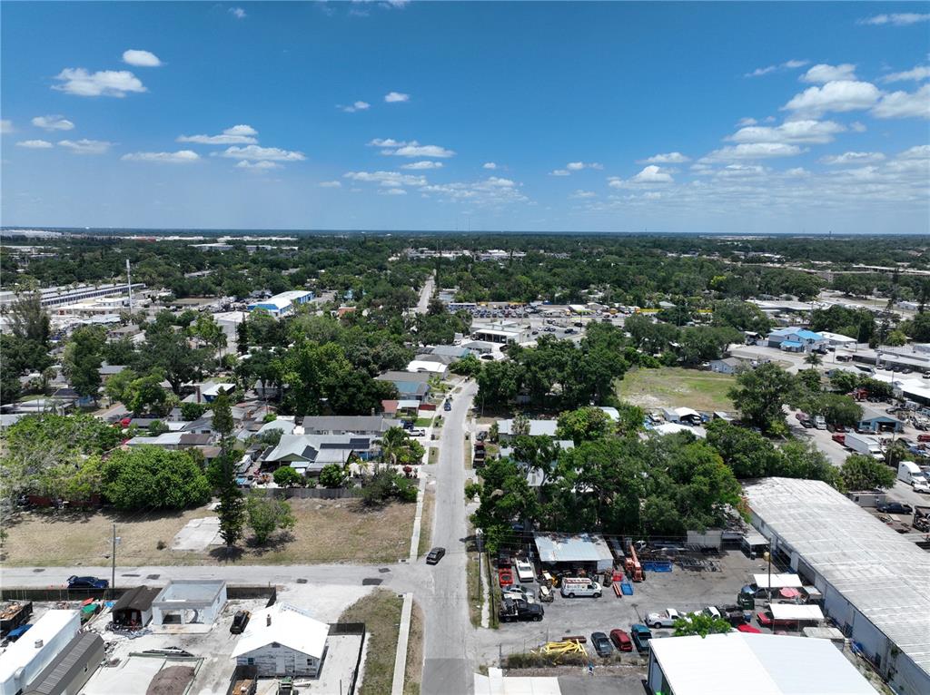 An aerial view shows a residential and industrial area with a road running through it — 1206 27TH AVENUE W, BRADENTON, FL