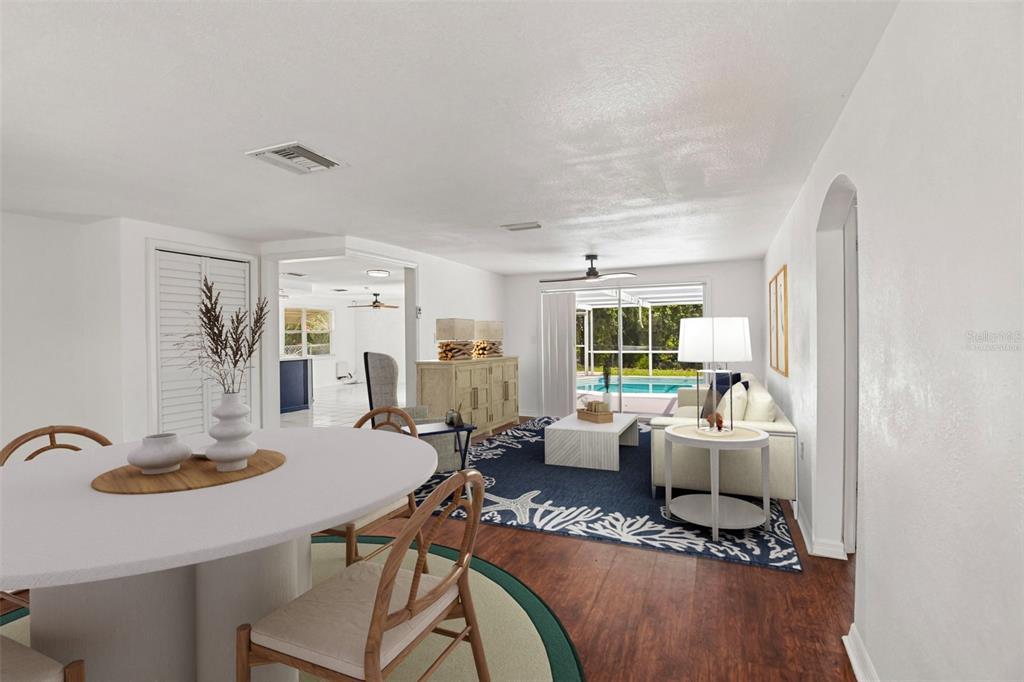 A dining area and living room with wood floors open to a screened-in pool patio — 7303 HEATH DRIVE, PORT RICHEY, FL