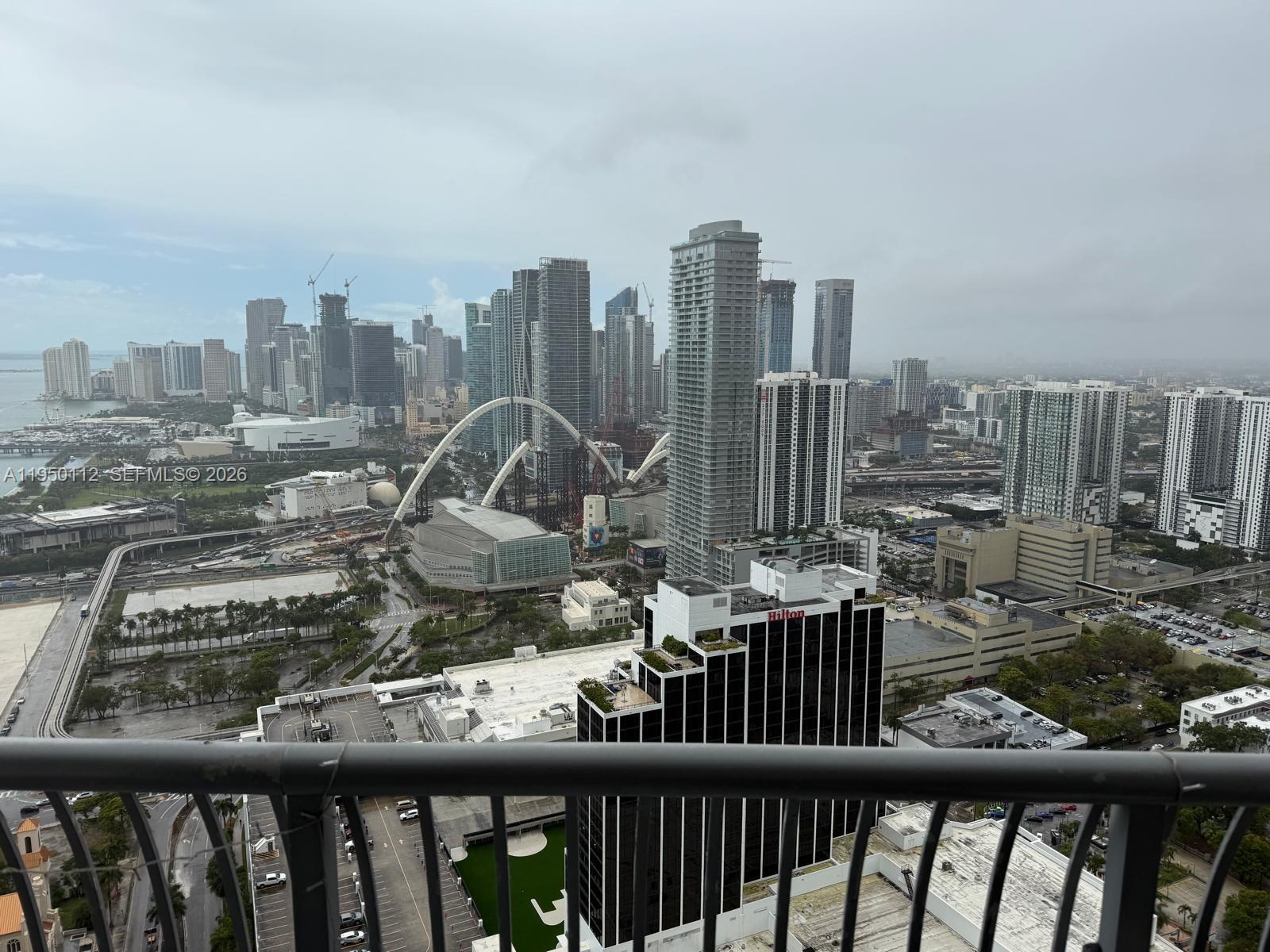 An elevated view of the Miami skyline featuring skyscrapers, construction, and a Hilton hotel — 1750 N Bayshore Dr # 4912, Miami FL 33132, MIAMI, FL