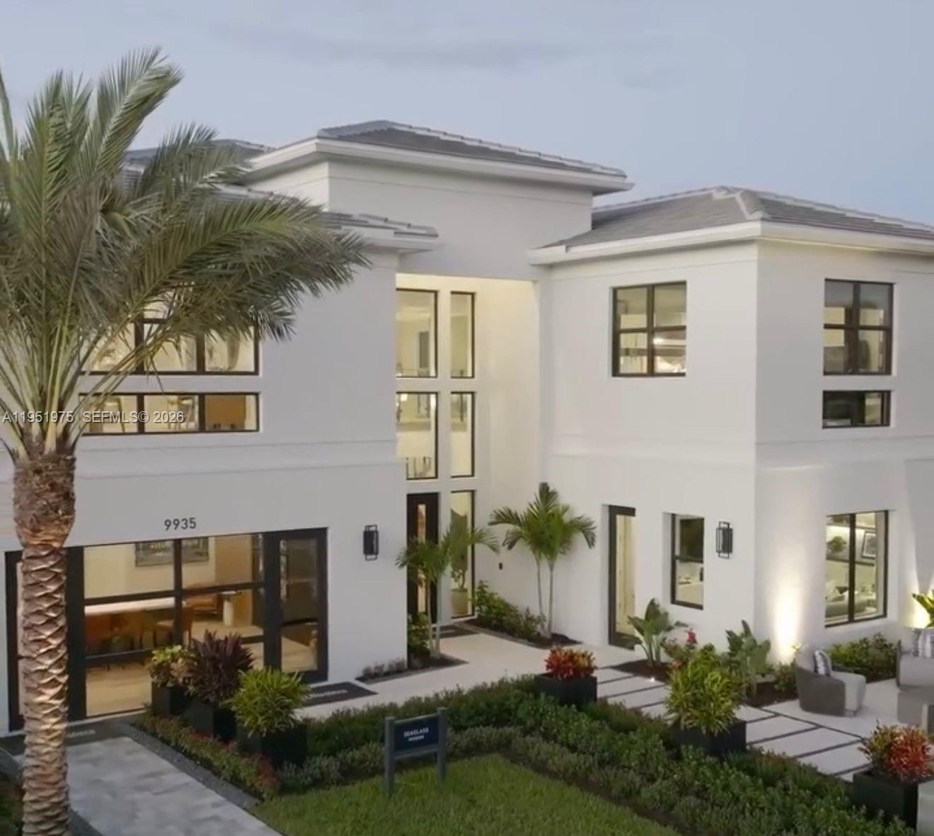 A modern two-story white house with large windows, a palm tree, and landscaped front yard — 17970 50th St N, Loxahatchee FL 33470, LOXAHATCHEE, FL
