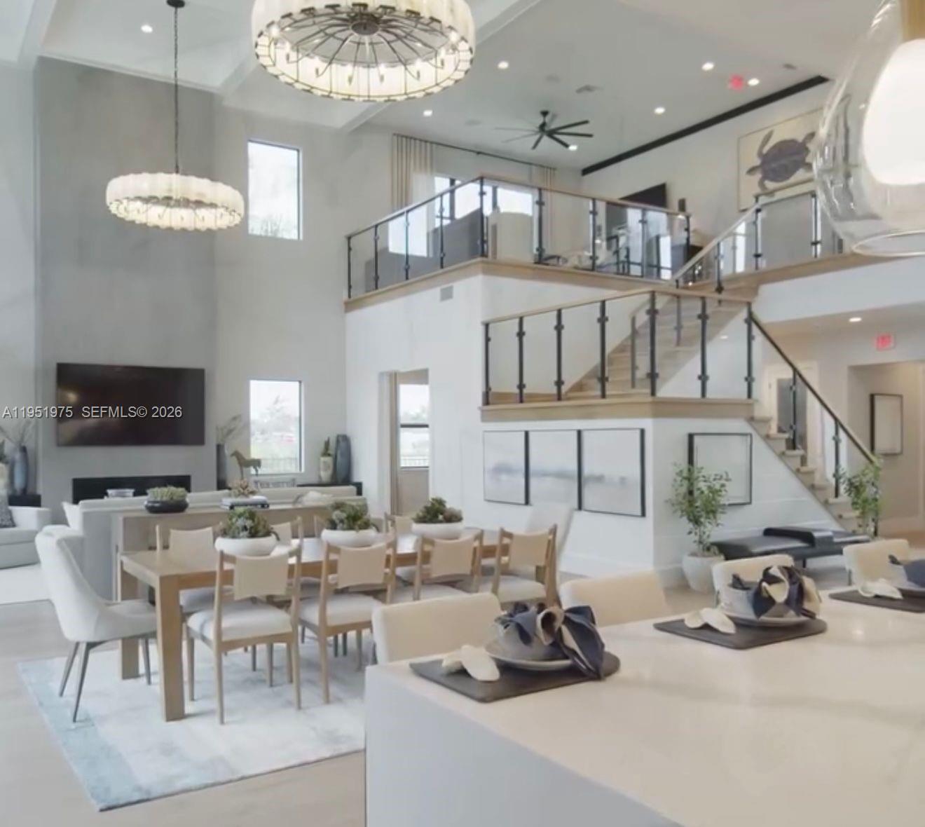 A spacious open-concept living and dining area features a grand staircase and high ceilings — 17970 50th St N, Loxahatchee FL 33470, LOXAHATCHEE, FL