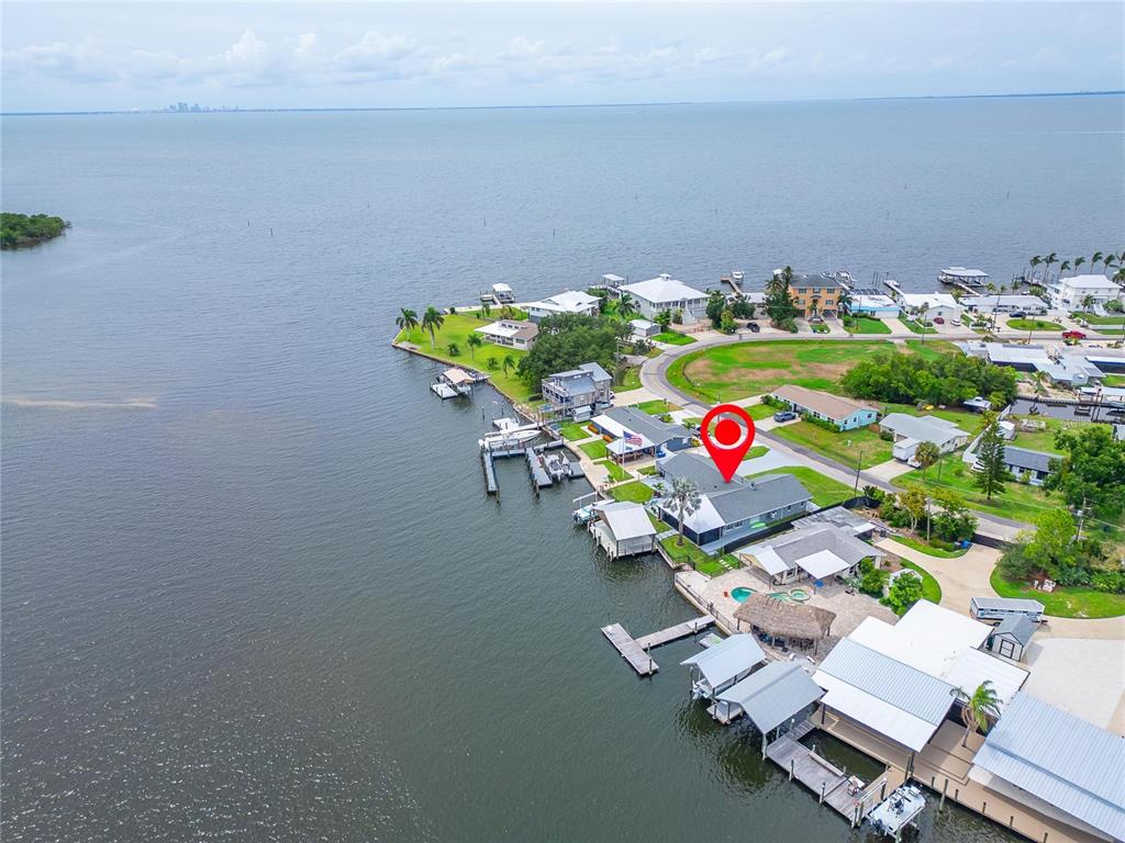 An aerial view shows a waterfront house with a private dock and pool — 3422 W SHELL POINT ROAD, RUSKIN, FL
