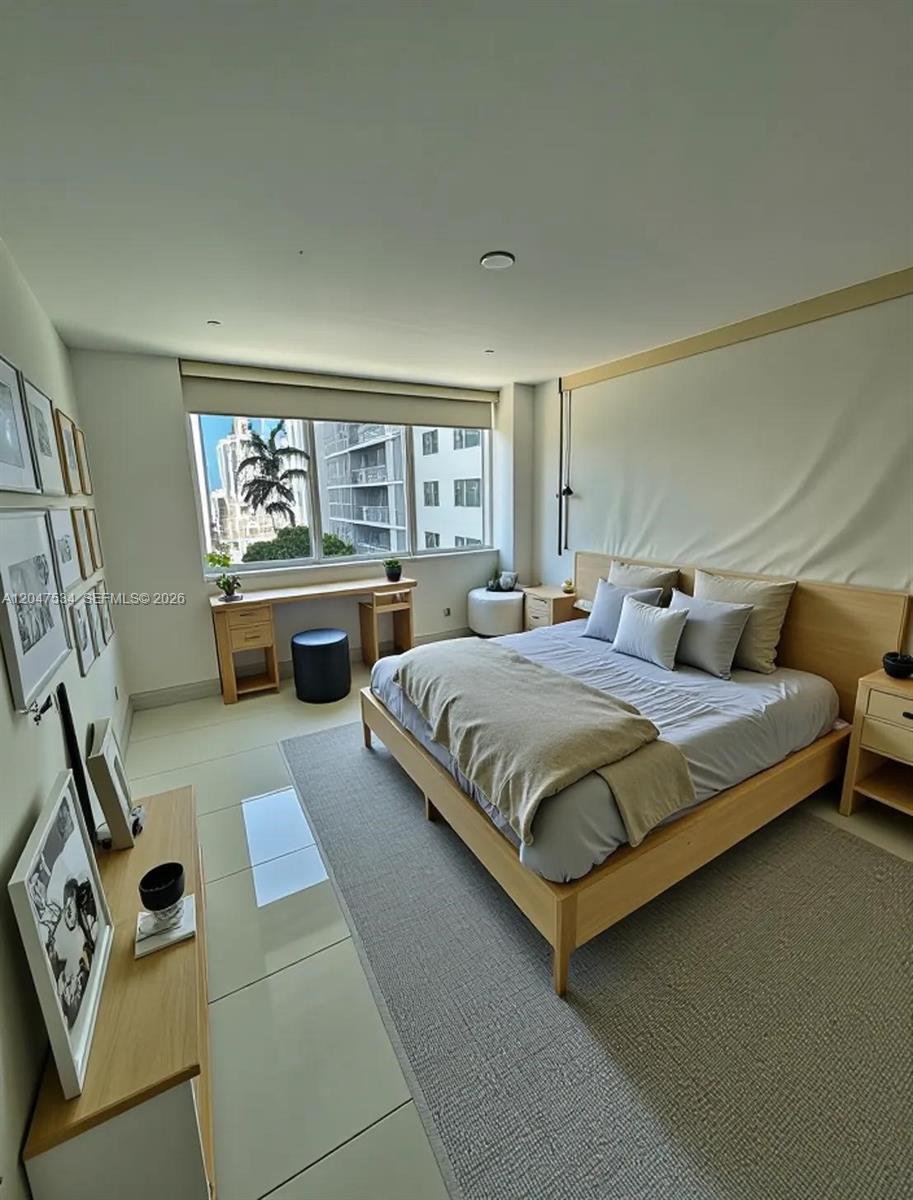 A modern bedroom features a light wood bed frame, a desk, and large windows — 244 Biscayne Blvd # 1009, Miami FL 33132, MIAMI, FL