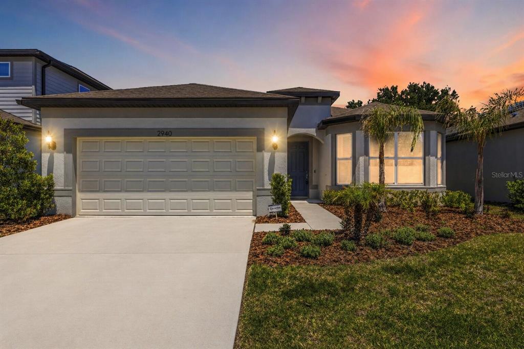 A single-story suburban house with a two-car garage and a landscaped front yard — 2940 FOREST MEADOW AVENUE, VALRICO, FL