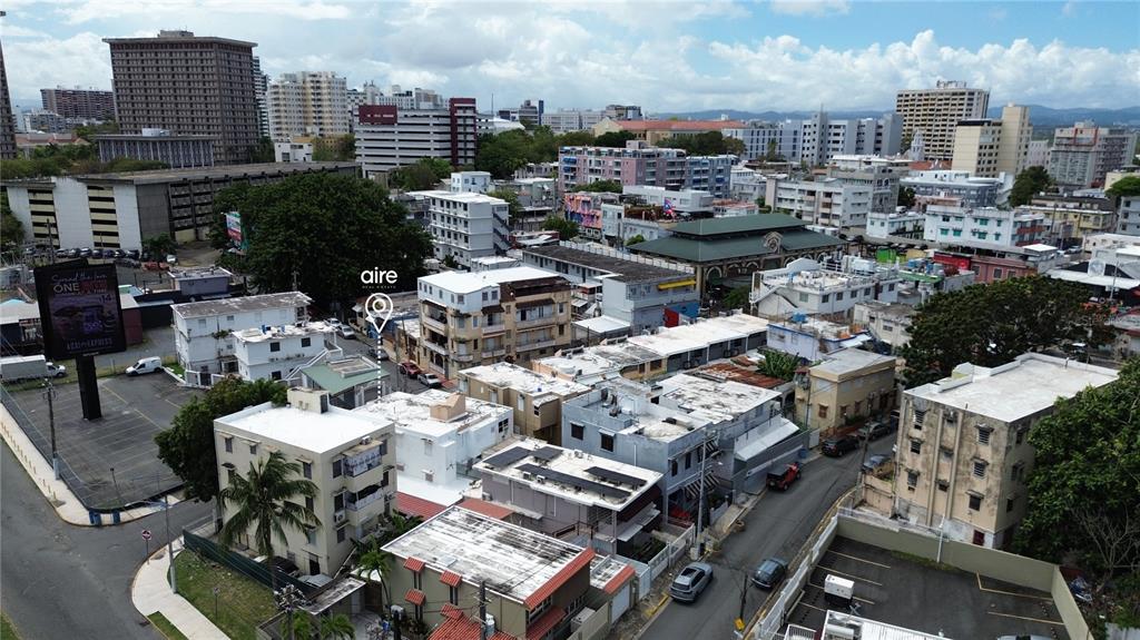 An aerial view of a dense urban neighborhood featuring multi-story buildings and city streets — 162 LA PLACITA DE SANTURCE, DOS HERMANOS, SAN JUAN, PR