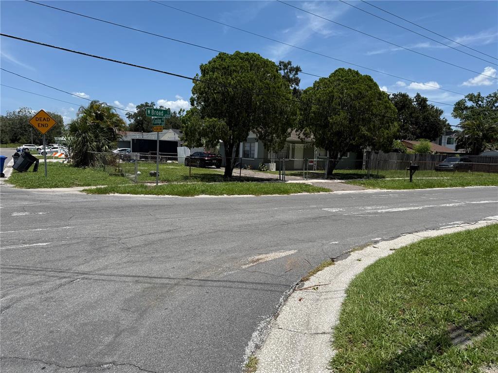 A single-story house sits behind a chain-link fence at a dead-end street intersection — 4305 W BROAD STREET, TAMPA, FL
