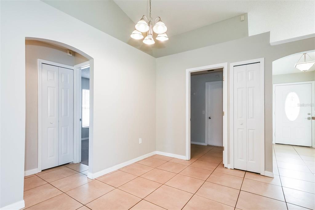 An interior view of a room with light-colored walls, tiled flooring, and white doors — 2807 ARBOUR TRAIL COURT, DELTONA, FL