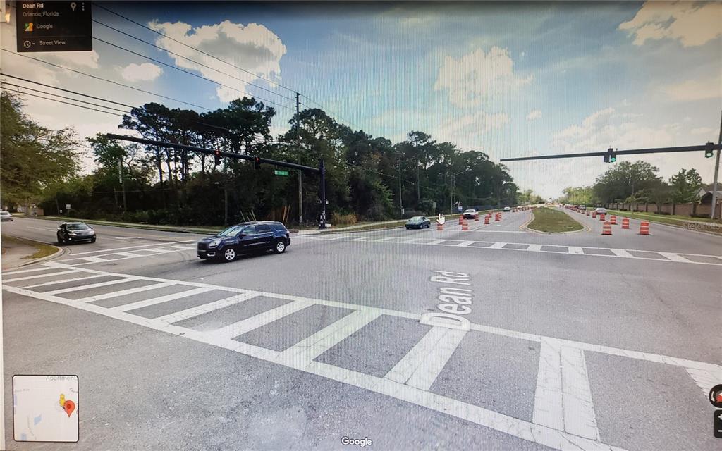 This street-level view shows an intersection with a crosswalk and traffic cones on Dean Road — 10000 BUCK ROAD, ORLANDO, FL