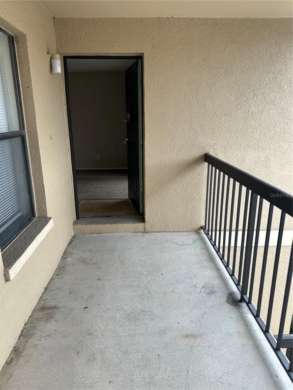 A sign for Mystic Gardens Condominiums stands behind a flower bed and a palm tree — 5331 SUMMERLIN ROAD UNIT 3112, FORT MYERS, FL