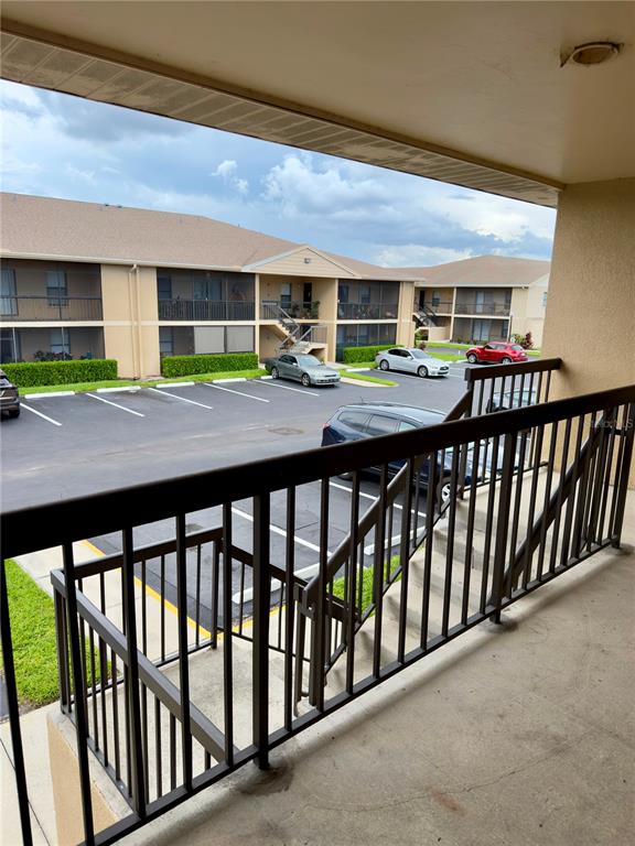 A concrete balcony with a black metal railing leads into an interior room — 5331 SUMMERLIN ROAD UNIT 3112, FORT MYERS, FL