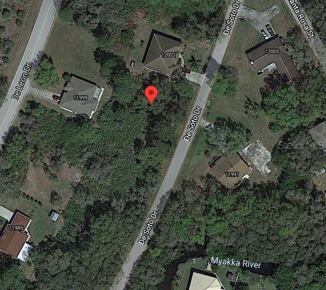 This is an aerial map view showing a vacant lot marked with a red pin — LOTS 44 & 45 DESOTO DRIVE, NORTH PORT, FL