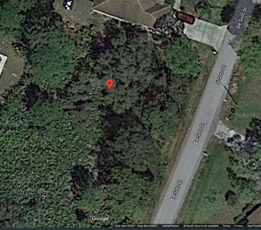This is a satellite map view of a vacant, wooded residential lot along a road — LOTS 44 & 45 DESOTO DRIVE, NORTH PORT, FL