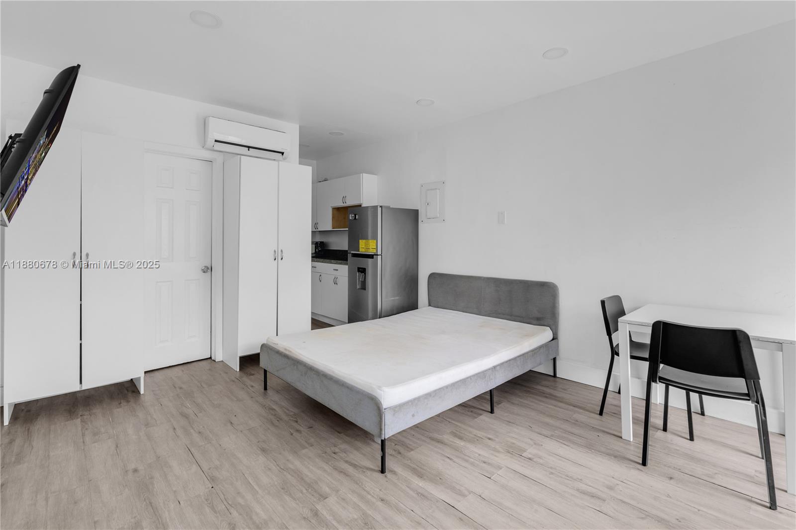 A studio apartment features a bed, a small kitchenette, and a dining area — 110 NW 9th Ave # 3, Miami FL 33128, MIAMI, FL