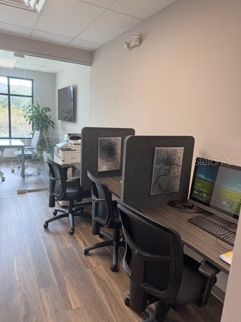 An office space features two desks with privacy dividers, rolling chairs, and a glass-walled conference area — 13550 VILLAGE PARK DRIVE UNIT GE, ORLANDO, FL