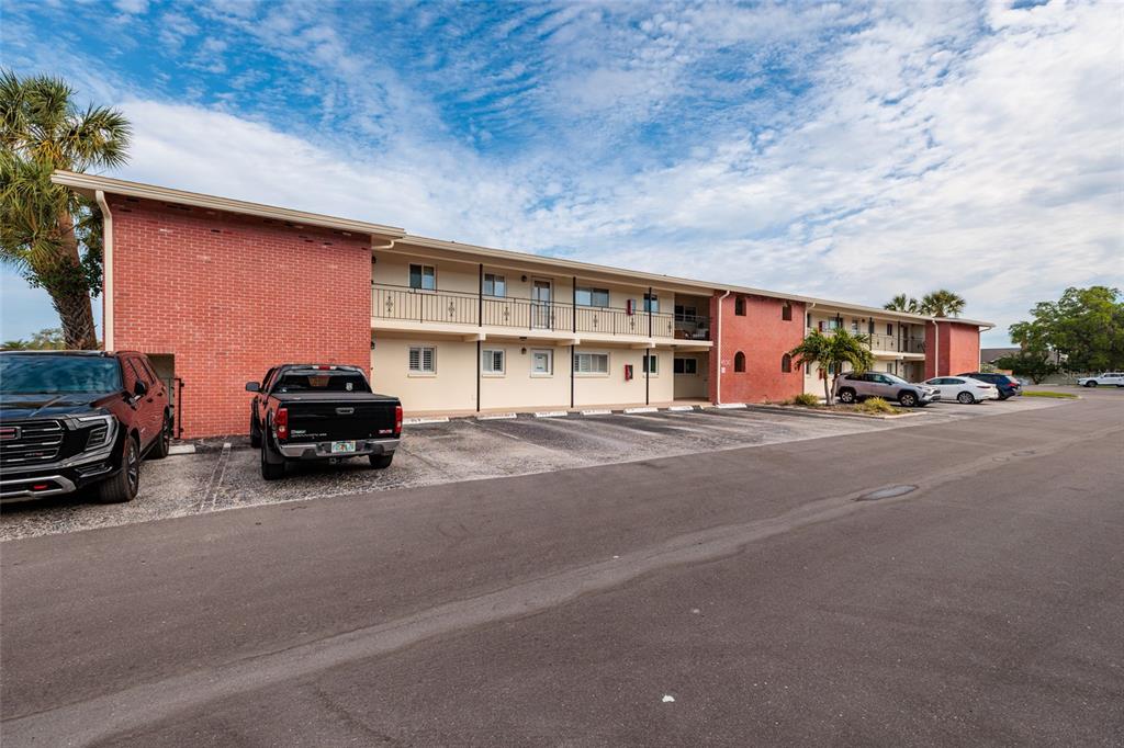 A two-story apartment building with a brick facade and a parking lot in front — 4550 OVERLOOK DRIVE NE UNIT 154, ST PETERSBURG, FL