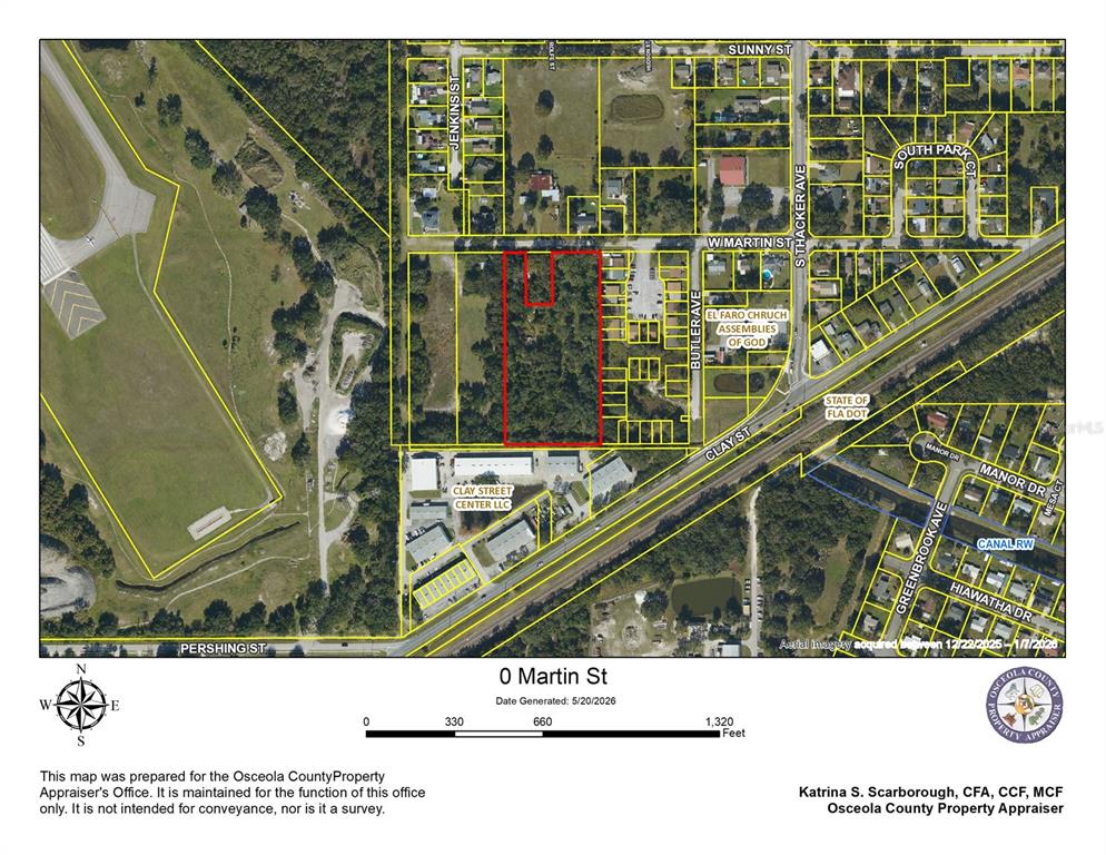 This is a property appraiser's aerial map showing a highlighted parcel of land — W MARTIN STREET, KISSIMMEE, FL