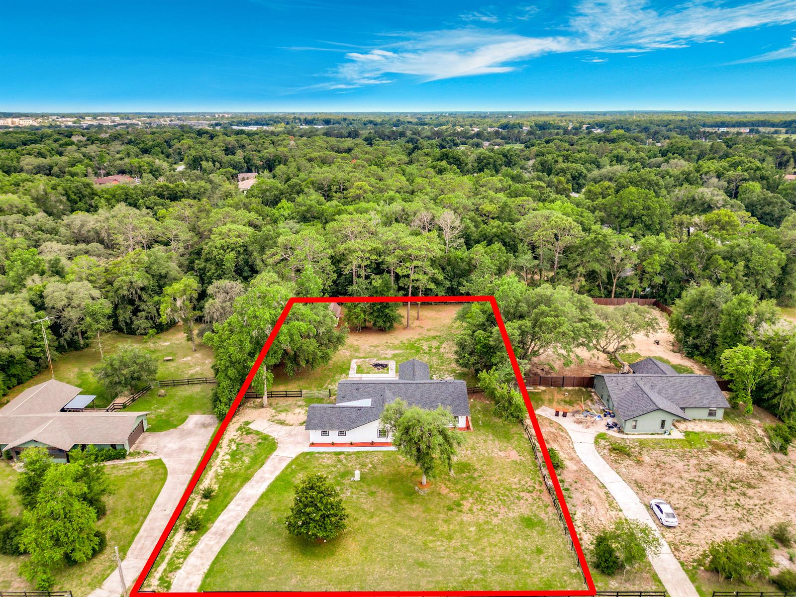An aerial view shows a white house with a dark roof centered on a grassy lot — 5534 SW 31st Street, Ocala FL 34474, OCALA, FL