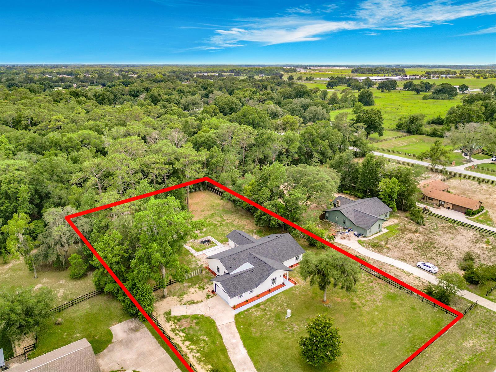 An aerial view shows a white house with a dark roof on a fenced lot — 5534 SW 31st Street, Ocala FL 34474, OCALA, FL