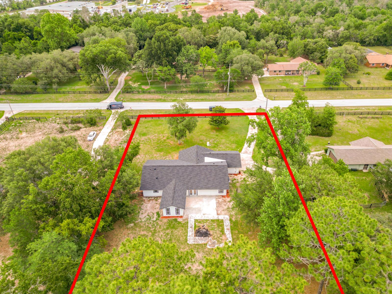 An aerial view shows a white house with a dark roof on a wooded lot — 5534 SW 31st Street, Ocala FL 34474, OCALA, FL