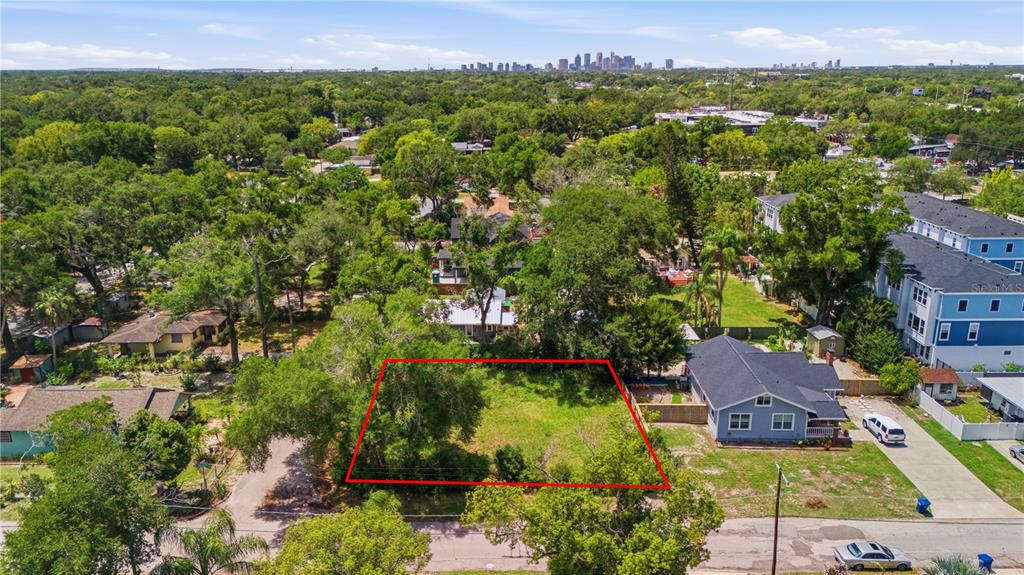 An aerial view shows a vacant rectangular lot outlined in red next to a house — 6612 N 9TH STREET, TAMPA, FL