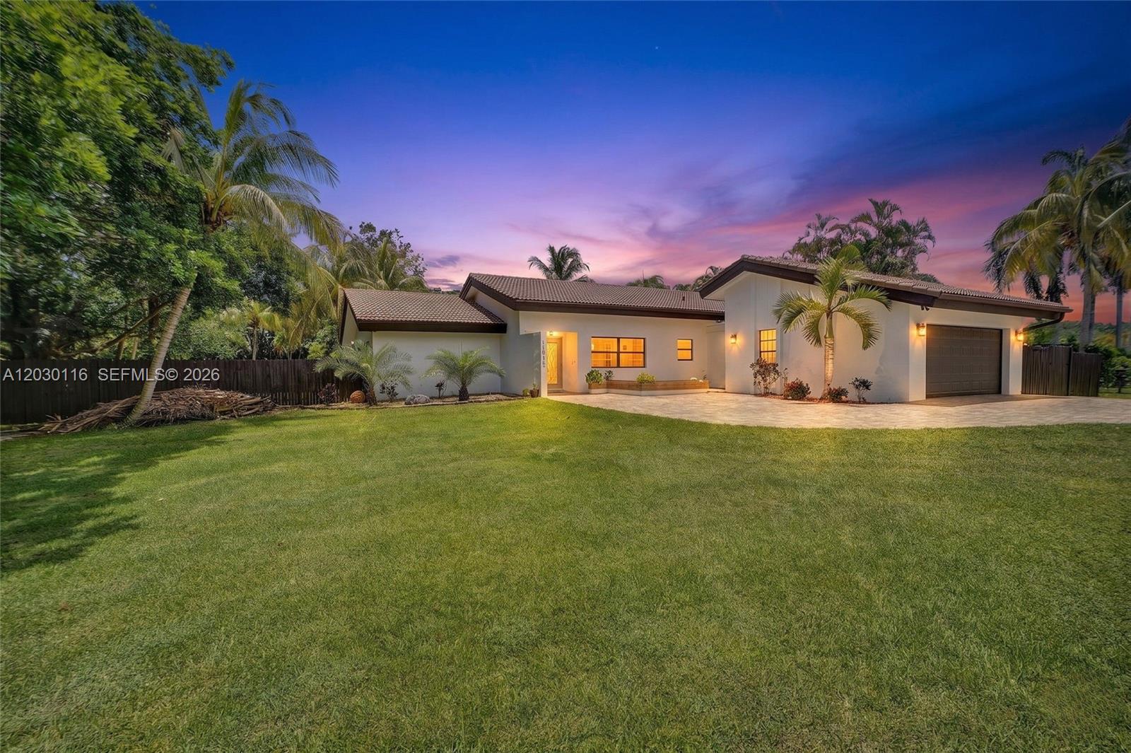 A single-story house with a paved driveway, palm trees, and a large front lawn — 11460 SW 1st Ct, Plantation FL 33325, PLANTATION, FL