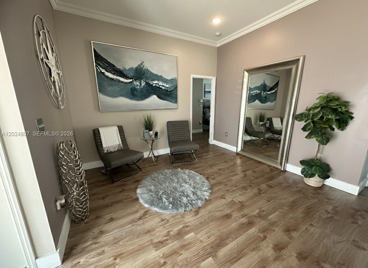 A room features two gray chairs, a round rug, wall art, and a large mirror — 14127 SW 161st Pl, Miami FL 33196, MIAMI, FL