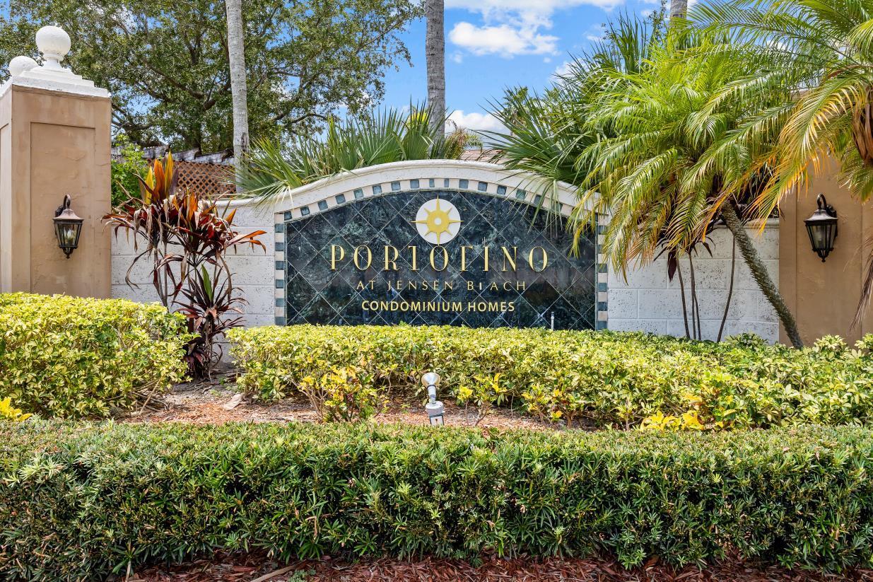 A stone monument sign for Portofino at Jensen Beach Condominium Homes sits behind landscaped bushes — 3721 NW Mediterranean Lane # 304, Jensen Beach FL 34957, JENSEN BEACH, FL