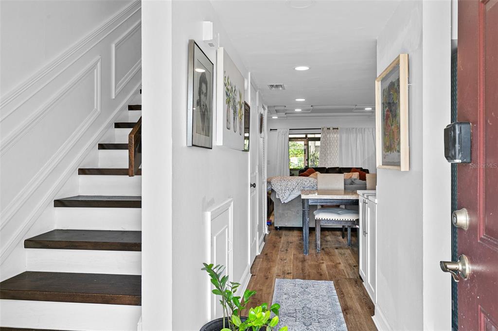 A view from an entryway looking toward a dining area and living room with stairs — 7223 CLOISTER DRIVE UNIT 111, SARASOTA, FL